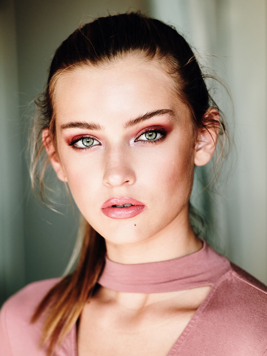 Striking beauty portrait of Wilhelmina model Kenzie Sponer with green eyes and bold red eyeshadow