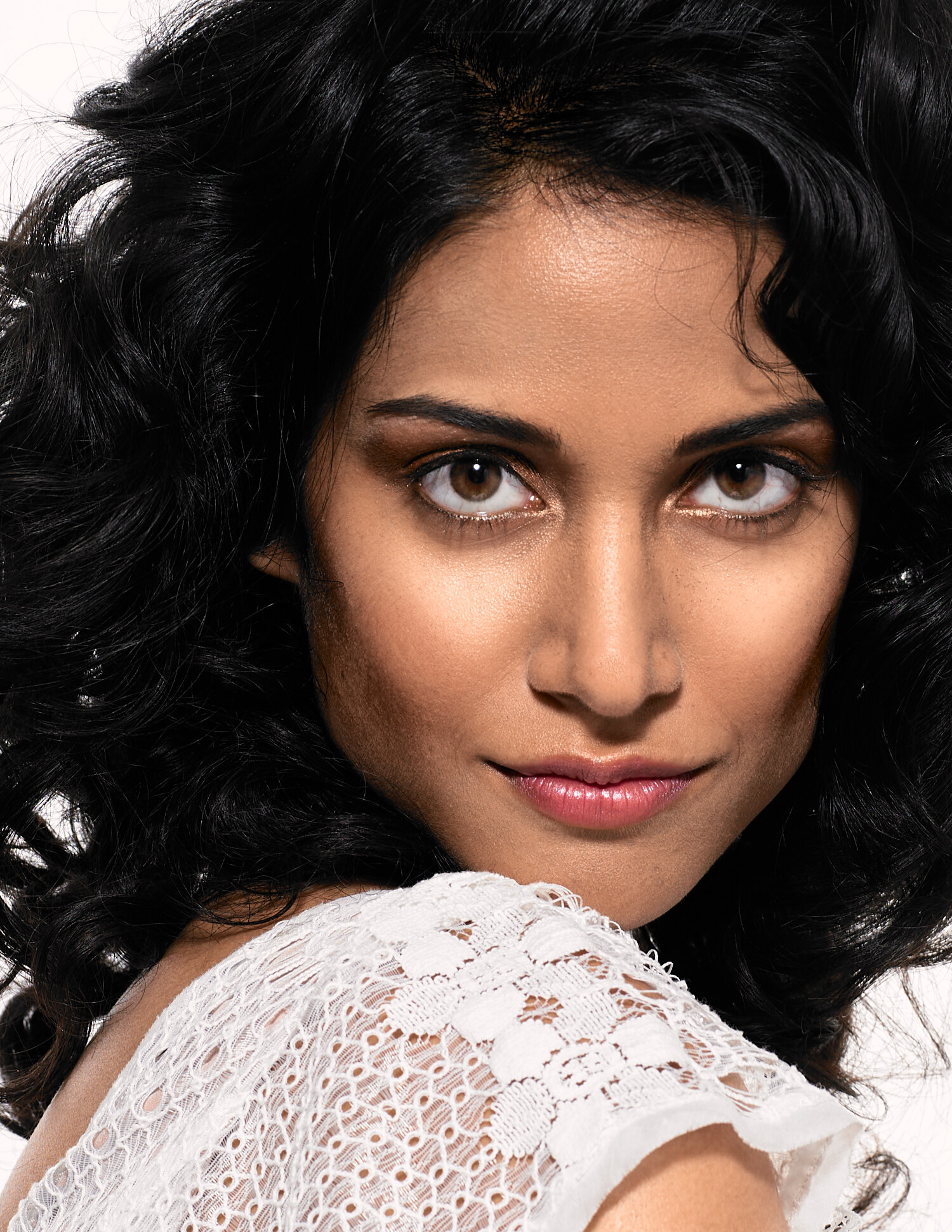 Melanie Chandra beauty close-up from the Hair magazine shoot, soft waves and natural glam in a white lace top. Beauty photography by Jason Guffy.