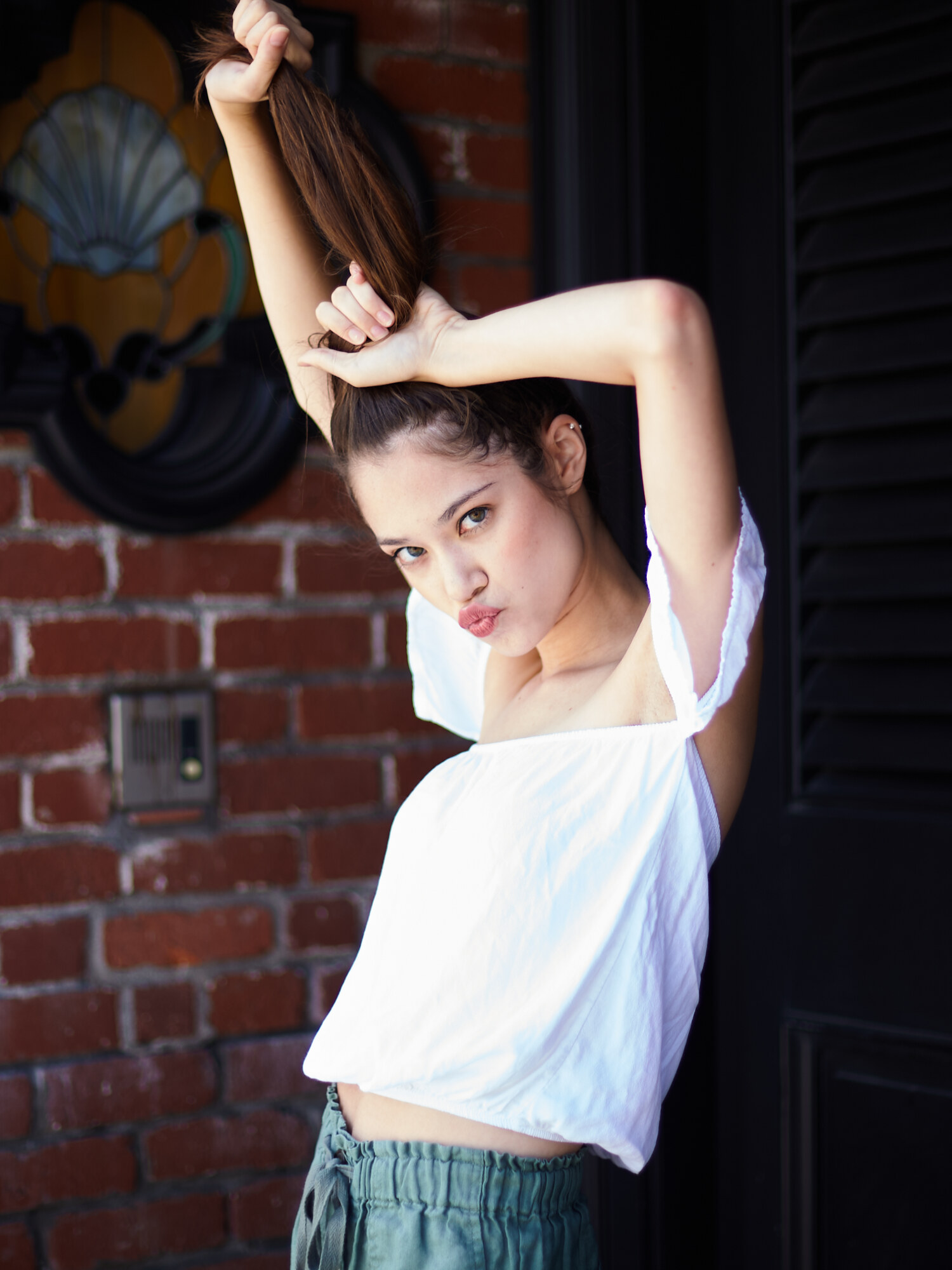 Coastal lifestyle portrait with a sculptural hair gesture, on location in Newport Beach, California. Fashion photography by Jason Guffy.