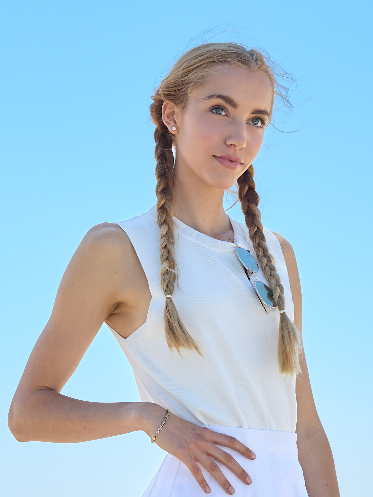 Outdoor fashion portrait in bright natural light, white top under a clear blue sky, Southern California. Fashion photography by Jason Guffy.