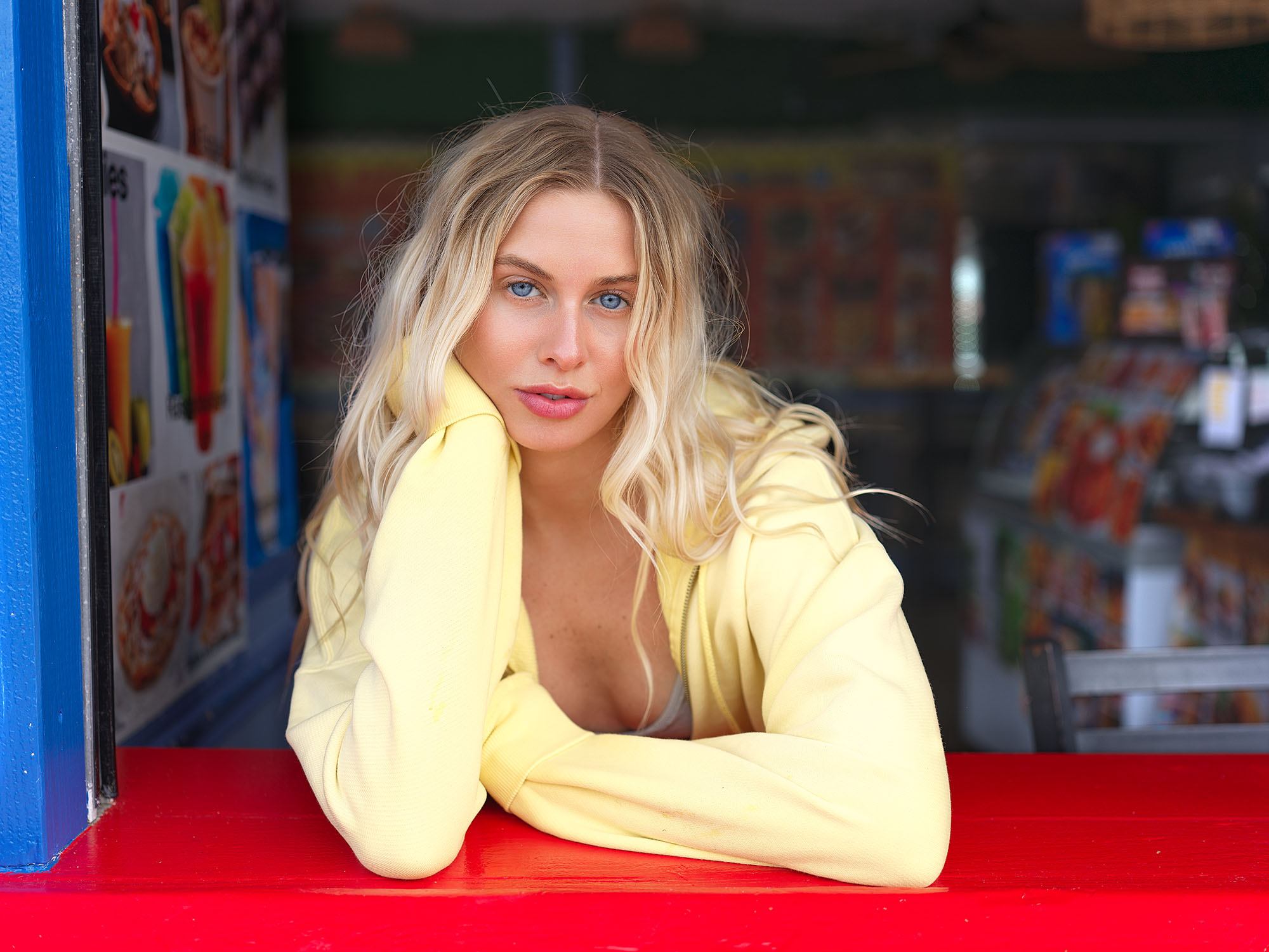 Lifestyle fashion portrait of model at colorful beach food stand window. Jason Guffy Photography.