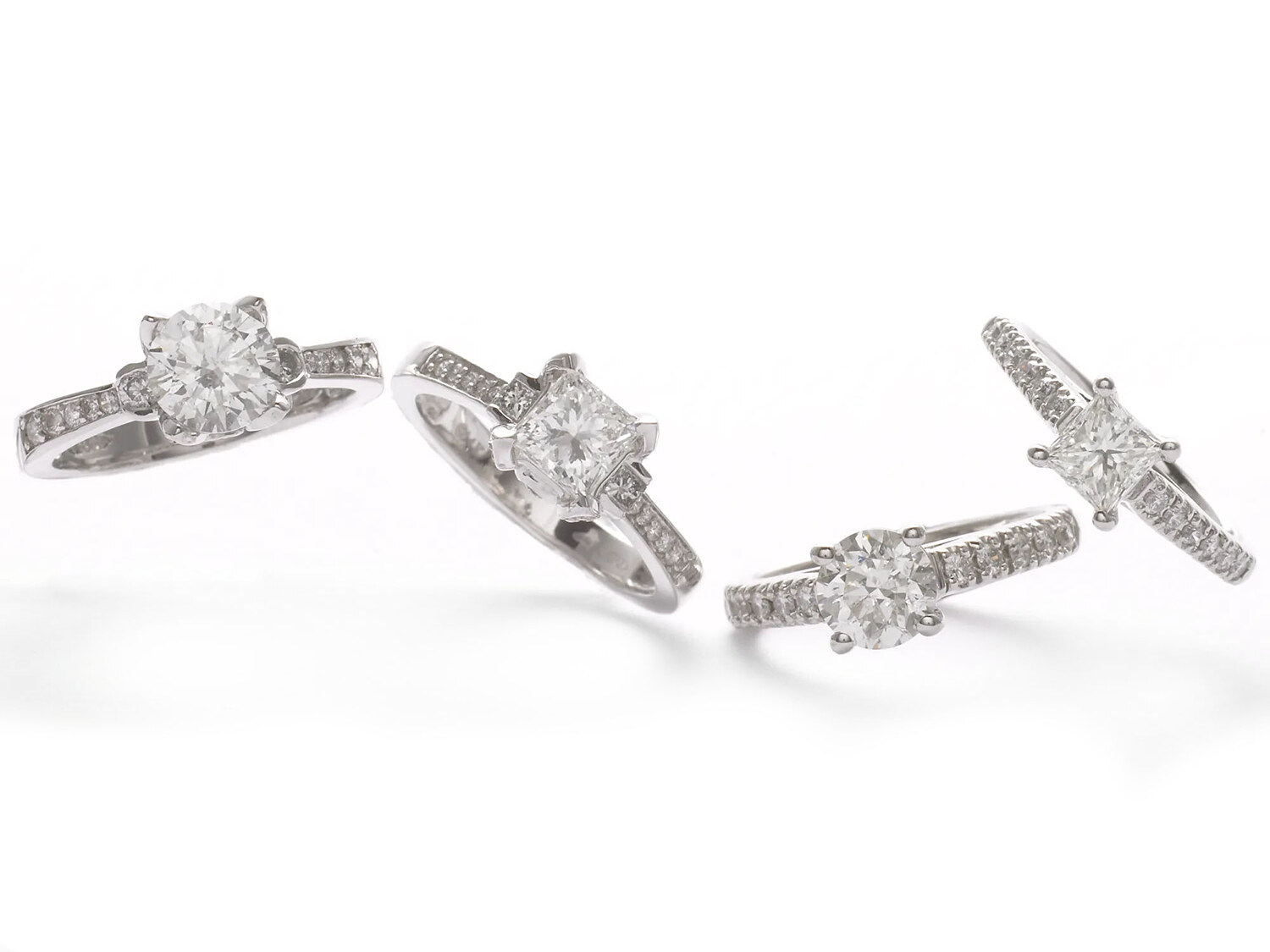 Platinum diamond engagement rings on a white background, fine jewelry e-commerce. Product photography by Jason Guffy.