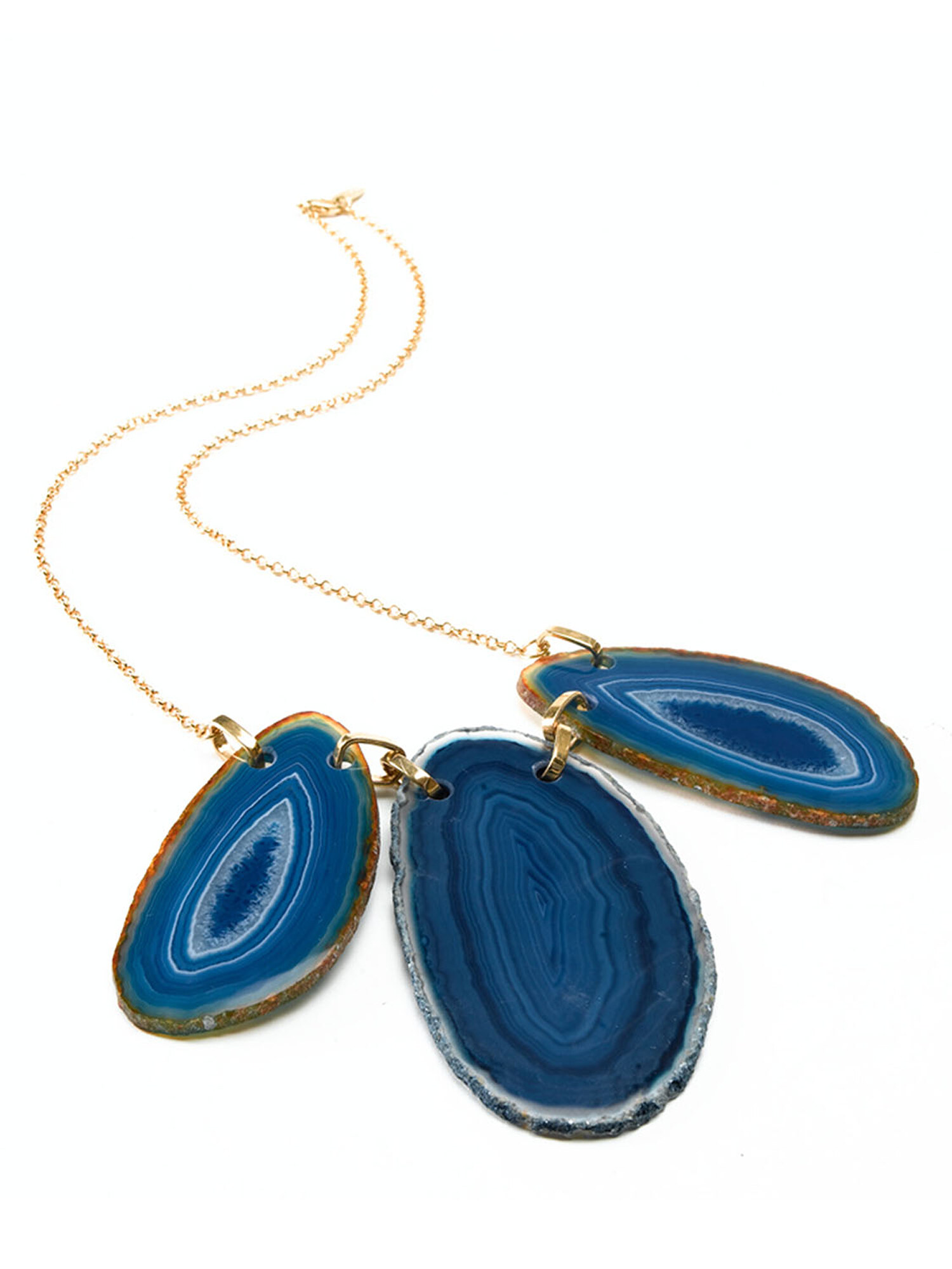 Gold fine-jewelry necklace with lapis pendants on a white background. Product photography by Jason Guffy.