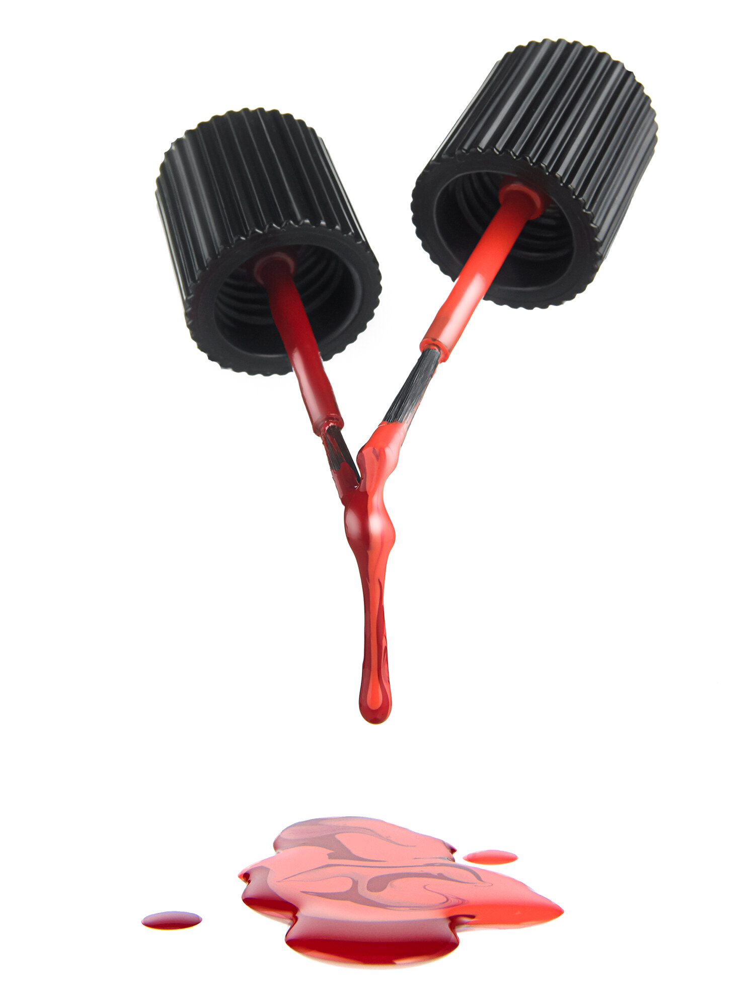 Chanel red nail polish with brushes dripping, styled beauty product photography for luxury advertising. Studio product photography by Jason Guffy.