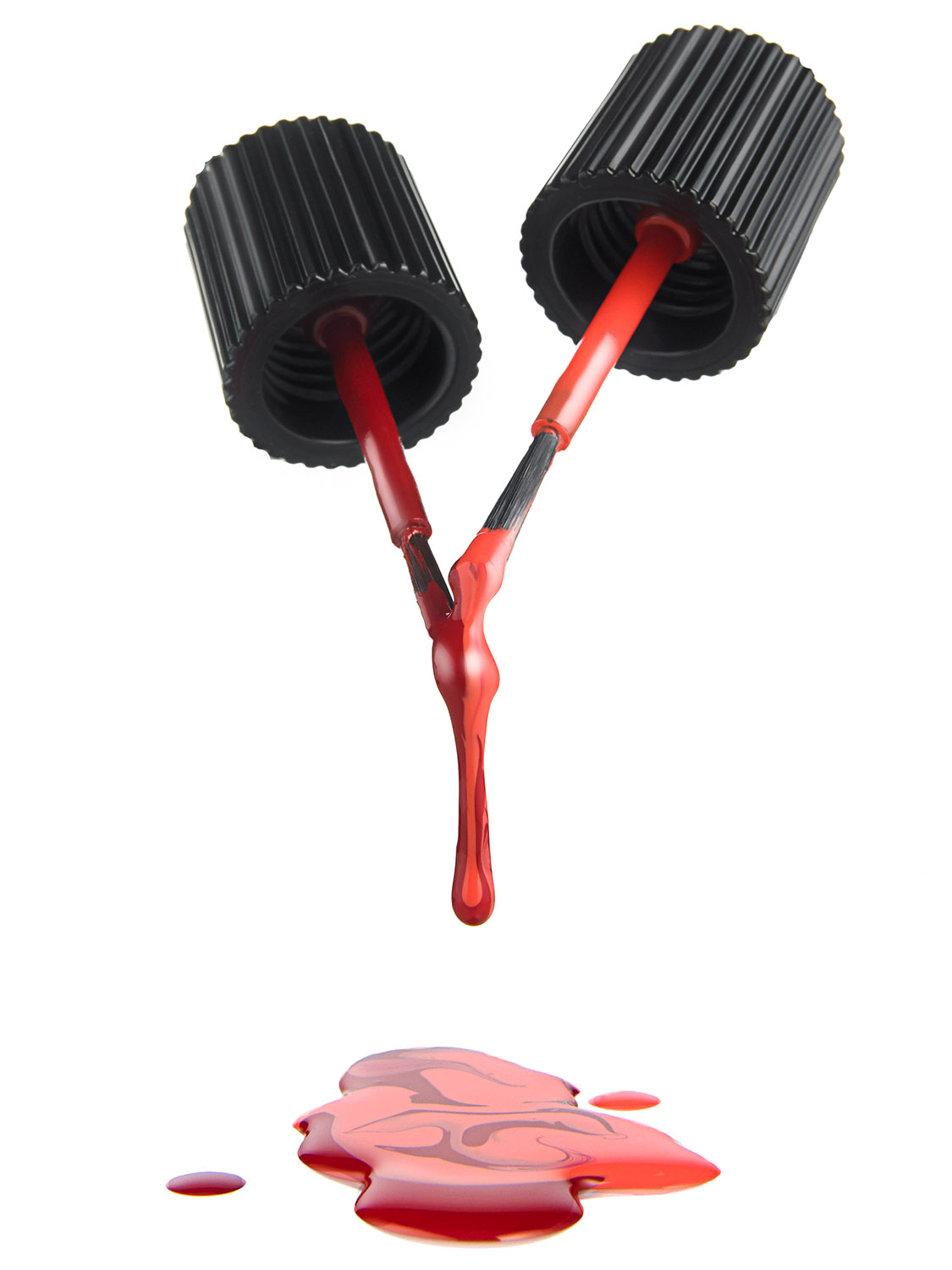 Chanel red nail polish with brushes dripping, styled beauty product photography for luxury advertising. Studio product photograph for commercial campaigns.