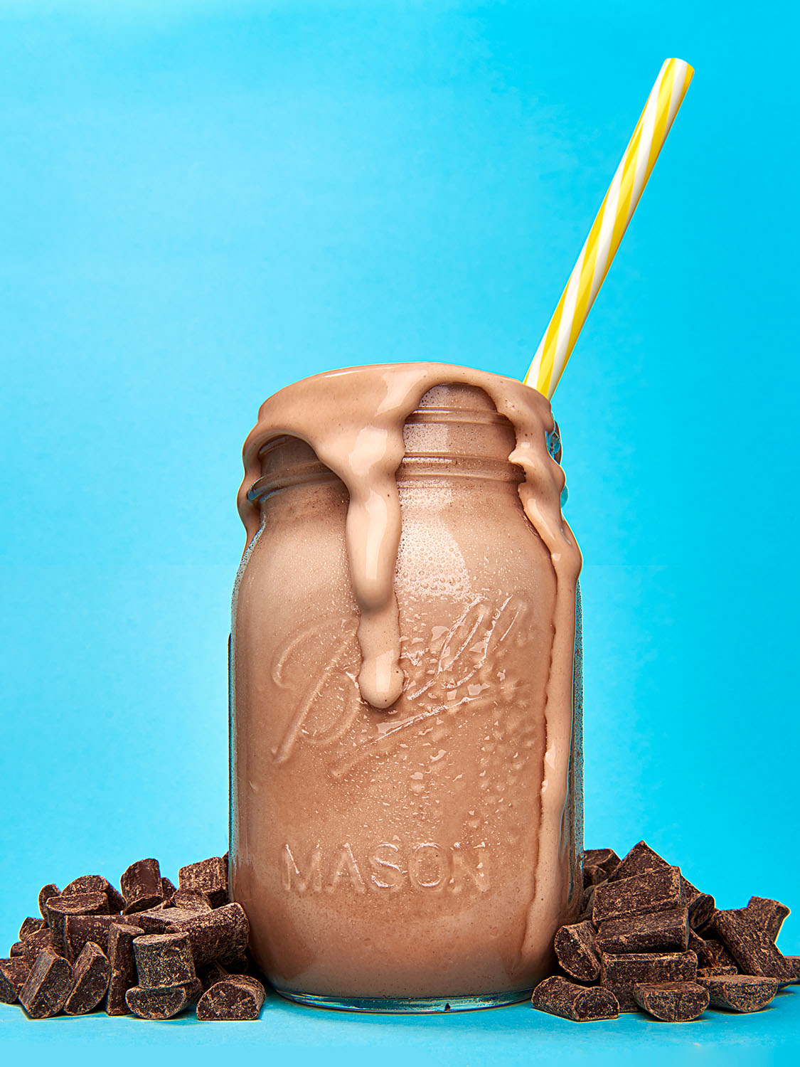 Commercial chocolate milkshake beverage photography in a Mason jar with chocolate chunks. Commercial product photography, San Diego.