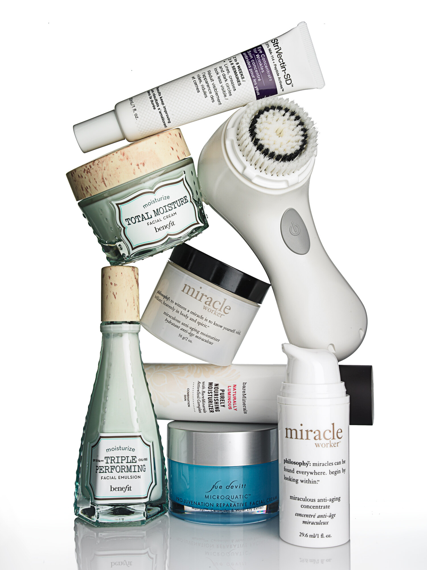Stacked still life of luxury skincare products and a Clarisonic cleansing brush, Macy's beauty collection. Product photography by Jason Guffy.