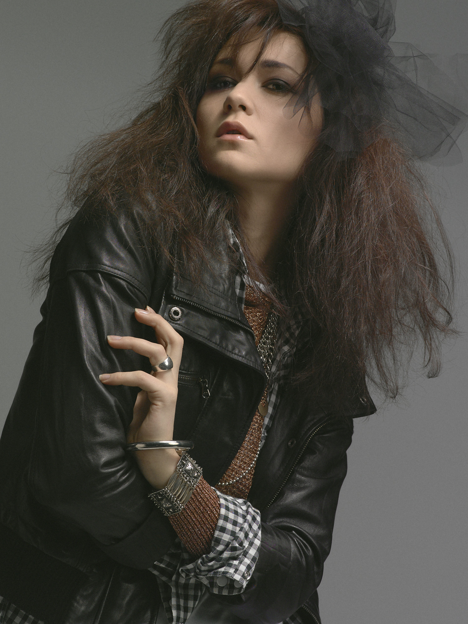 Studio rock editorial, a moody close in a leather jacket with black tulle in the hair. Hair by DJ Quintero. Jason Guffy Photography.