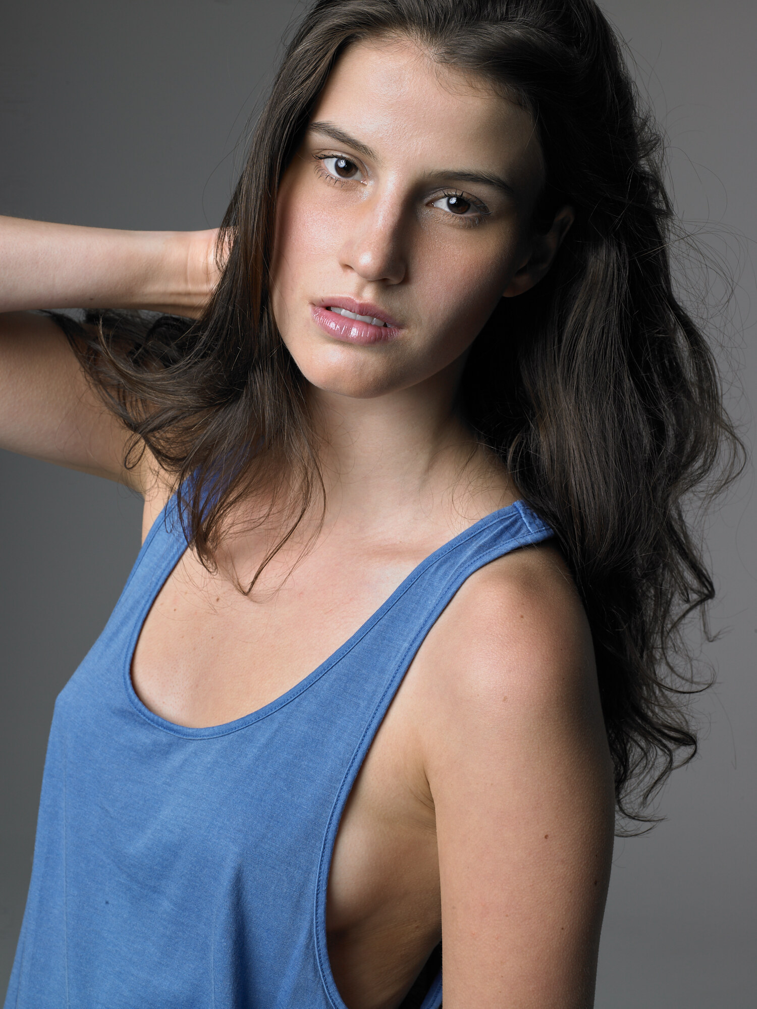 Studio portrait in a blue tank with natural makeup and soft studio light. Portrait photography by Jason Guffy.